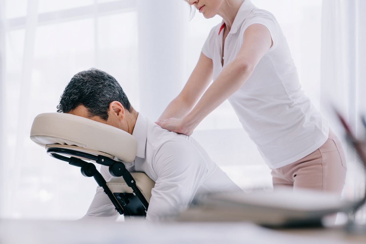 masseuse-doing-seated-back-massage-for-businessman-2024-11-17-08-32-08-utc